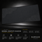 Minimal Graphite Shadow desk mat floating against a dark studio background.