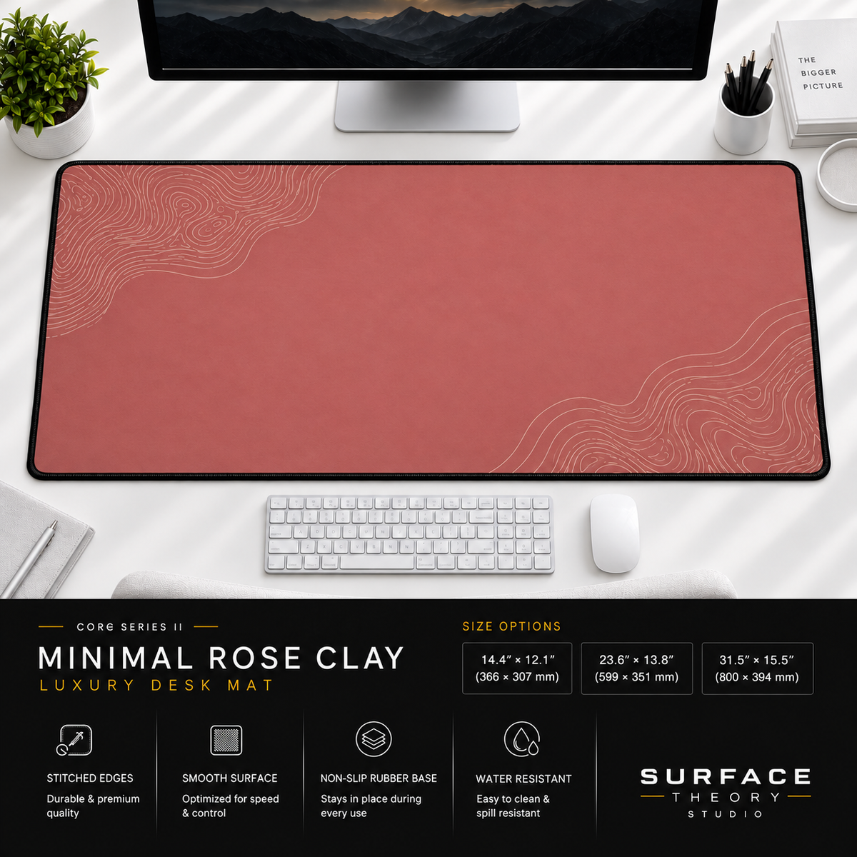 Minimal Rose Clay desk mat beneath a monitor on a bright desk with a white keyboard and mouse.