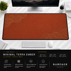 Minimal Terra Ember desk mat beneath a monitor on a bright desk with a white keyboard and mouse.
