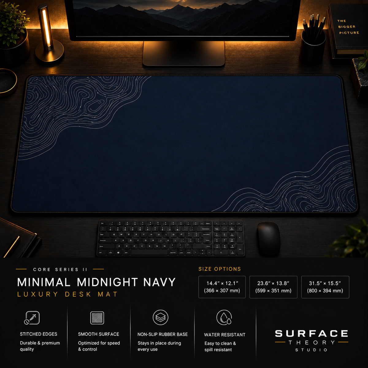 Minimal Midnight Navy desk mat in a dark workstation with warm monitor lighting.