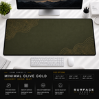Minimal Olive Gold desk mat beneath a monitor on a bright desk with a white keyboard and mouse.