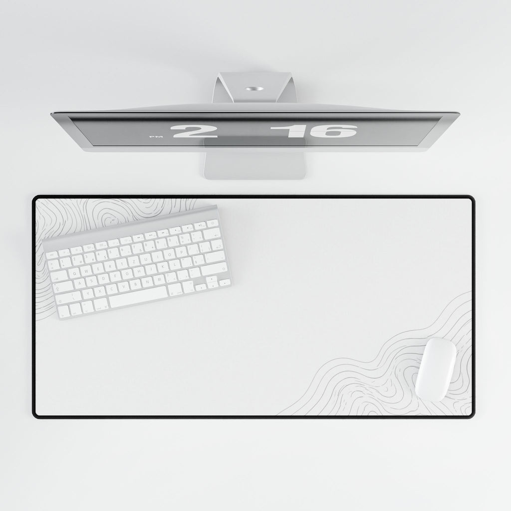 Overhead view of Minimal White desk mat beneath a keyboard and mouse on a white desk.