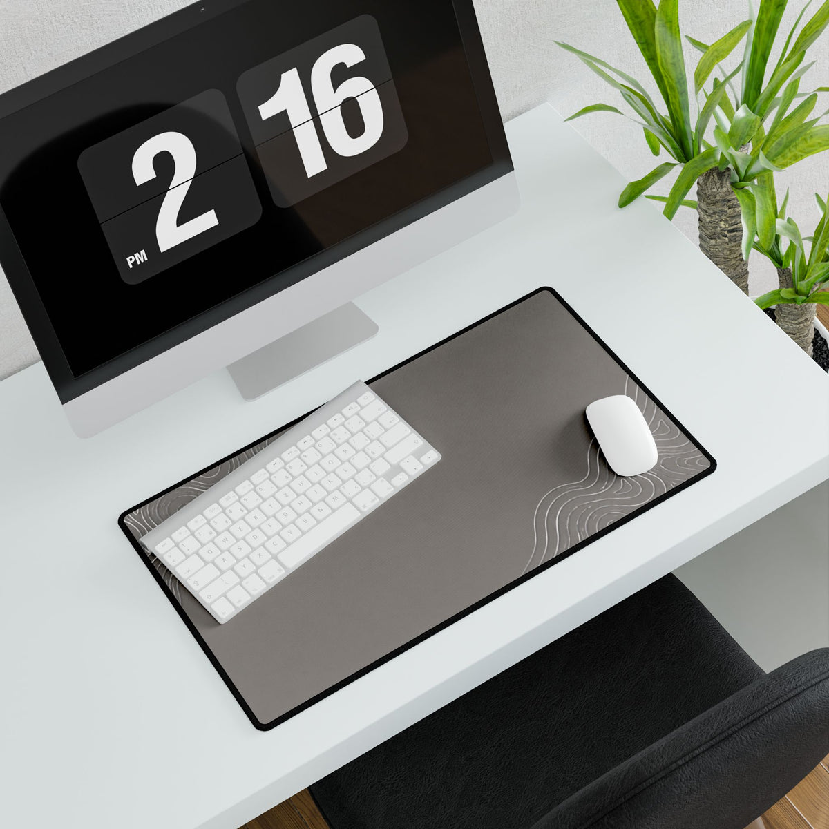 Minimal Stone Grey medium-format desk mat beneath a white keyboard and mouse, viewed at an angle.
