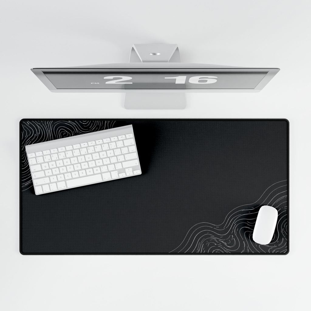 Overhead view of Minimal Charcoal desk mat beneath a keyboard and mouse on a white desk.